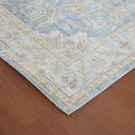 Corner of indigo blue and ivory rug with distressed medallion motif and border
