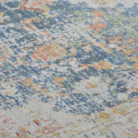 Close-up of indigo, ivory rug surface with multicolor distressed geometric pattern