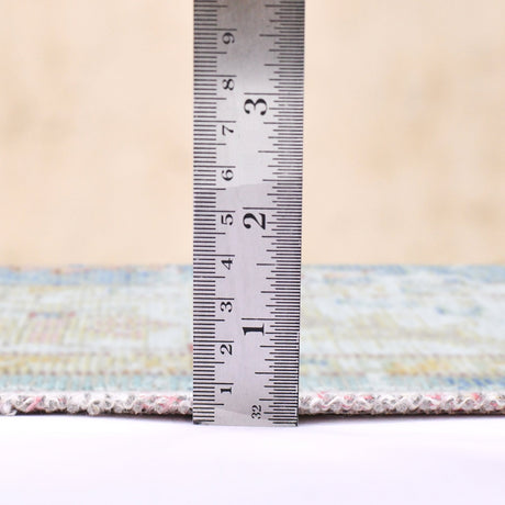 Indigo blue and ivory rug with textured border; includes height measurement ruler