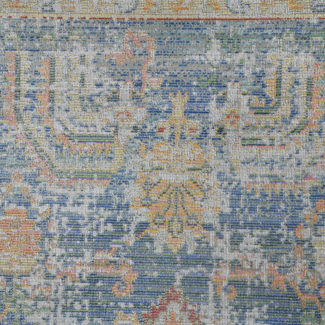 Close-up of indigo blue rug texture with orange and yellow accents in pattern