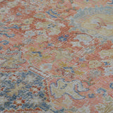 Distressed medallion area rug with coral, blue, and ivory tones