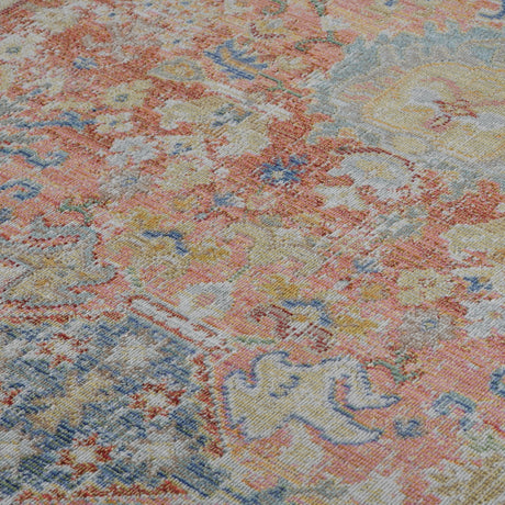 Distressed medallion area rug with coral, blue, and ivory tones