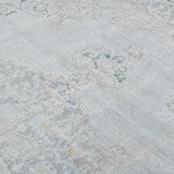 Sea mist medallion area rug with distressed geometric motifs and light blue highlights