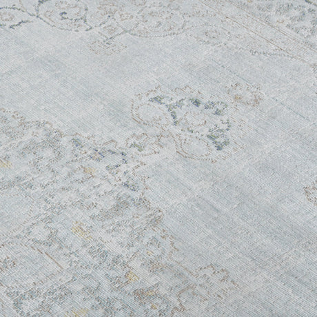 Sea mist medallion area rug with distressed geometric motifs and light blue highlights