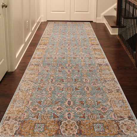 Teal distressed area rug laid in a hallway with ornate center medallion