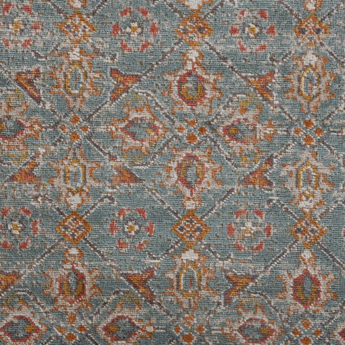 Teal area rug with diamond lattice and multicolor distressed motif pattern