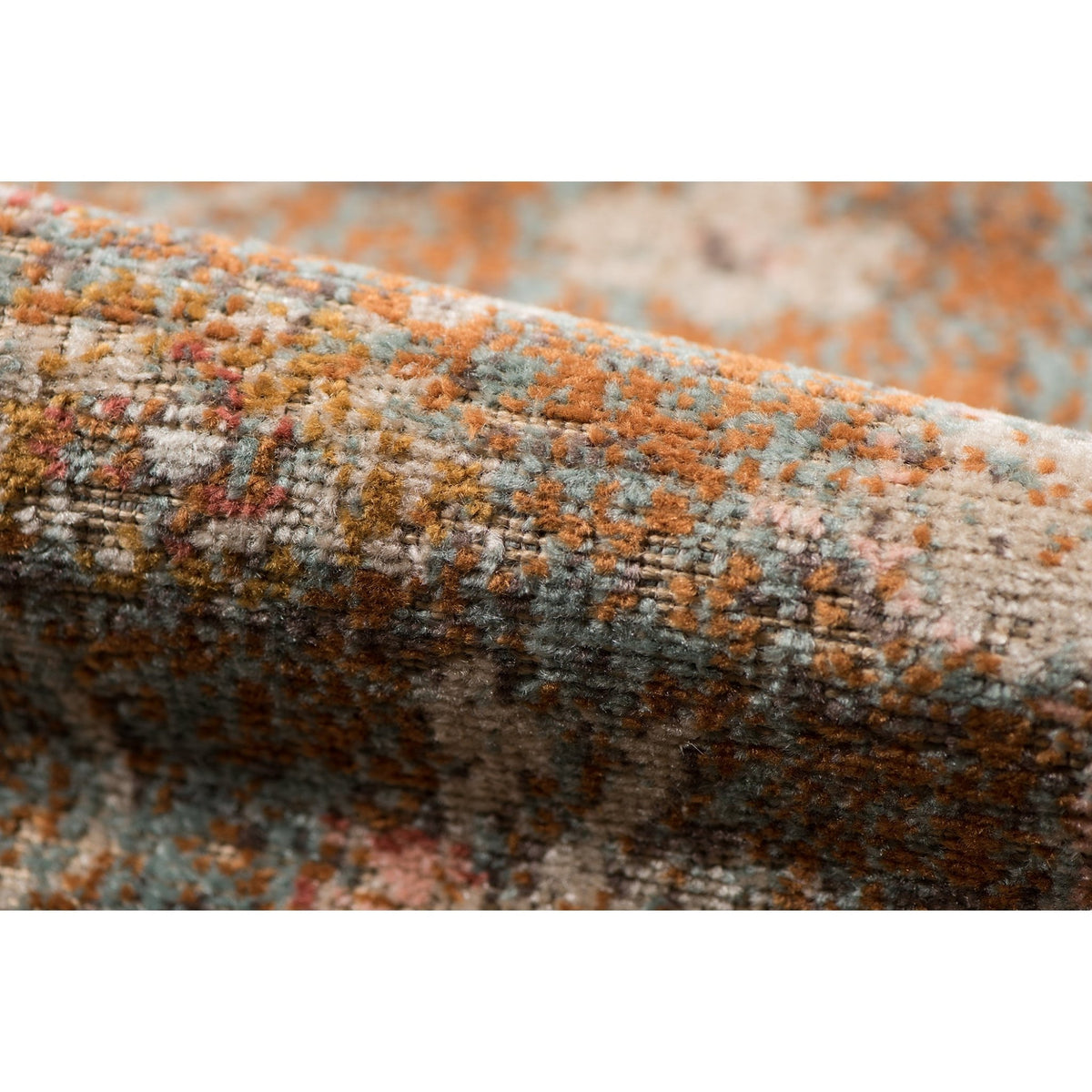 Textured edge of taupe medallion area rug with distressed multicolor woven pile