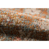 Textured edge of taupe medallion area rug with distressed multicolor woven pile