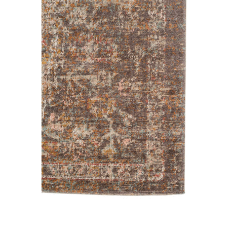 Taupe medallion area rug with scattered distressed motif pattern on rectangular surface