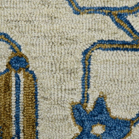 Hand-hooked floral area rug close-up of cream field with royal blue and gold patterned outlines