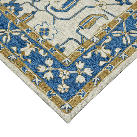 Hand-hooked floral area rug corner with cream field, royal blue motifs, and gold trim