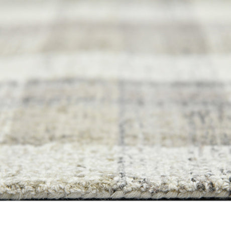 Hand-tufted rug border with short pile texture in light sand and gray.