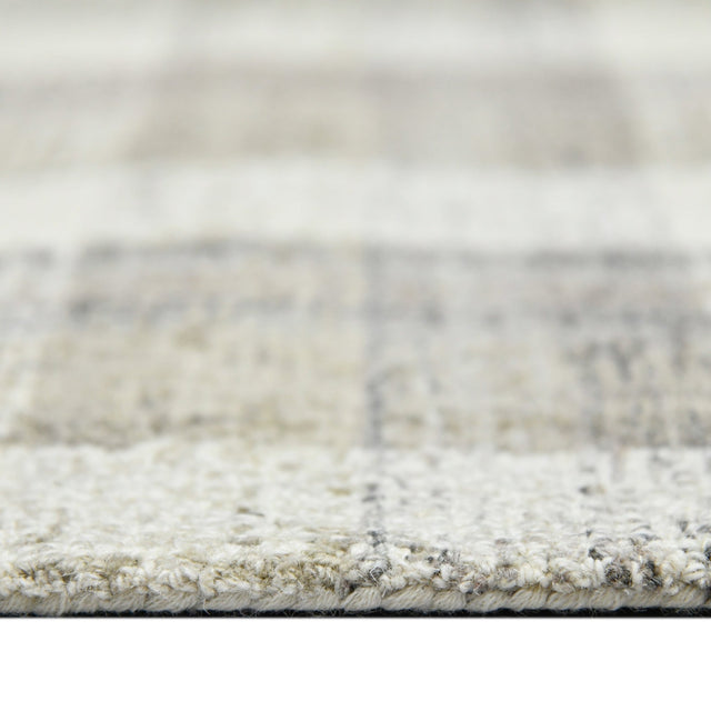 Hand-tufted rug border with short pile texture in light sand and gray.
