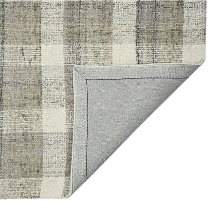 Corner view of rectangular plaid rug in beige and gray with clean stitched edge.