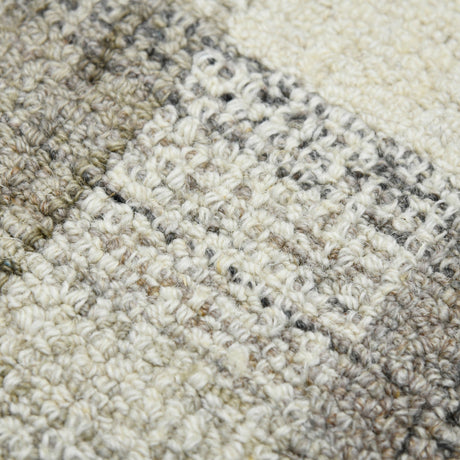 Sand and gray plaid hand-tufted rug with textured looped pattern detail.