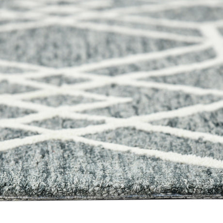 Low-angle view of gray geometric rug with off-white lattice pattern across surface
