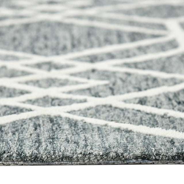 Low-angle view of gray geometric rug with off-white lattice pattern across surface