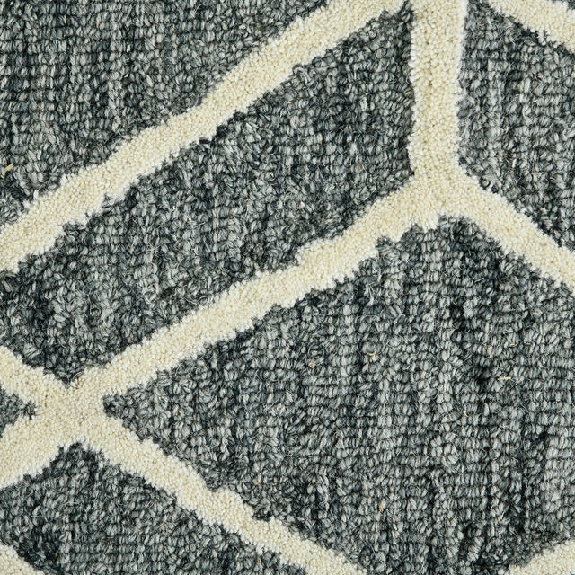 Close-up of textured gray rug with off-white diamond lattice pattern