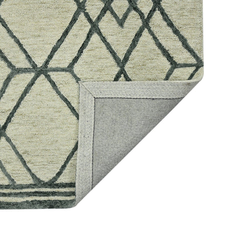 Ivory area rug corner with dark gray lattice pattern and stitched gray binding edge