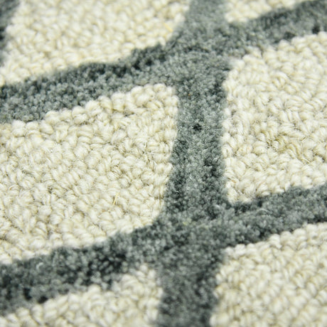Ivory geometric area rug with dark gray cross pattern, textured looped pile closeup