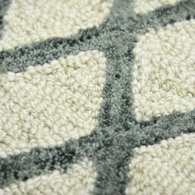 Ivory geometric area rug with dark gray cross pattern, textured looped pile closeup
