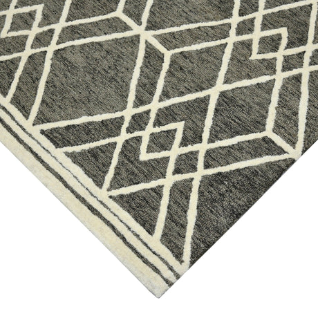 Hand-hooked area rug corner with off-white lattice lines on dark khaki background.