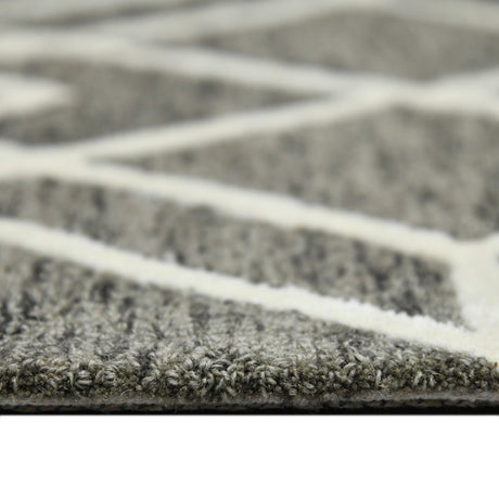Close-up of hand-hooked area rug pile in dark khaki with off-white pattern lines.