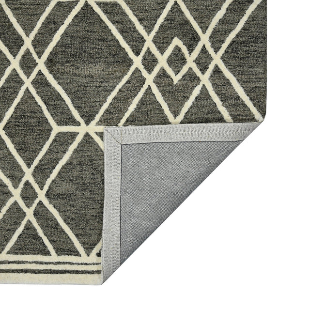 Hand-hooked area rug with khaki geometric diamond pattern and bordered corner.