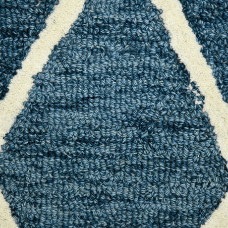 Tight close-up of navy rug section with cream intersecting lines and hooked texture