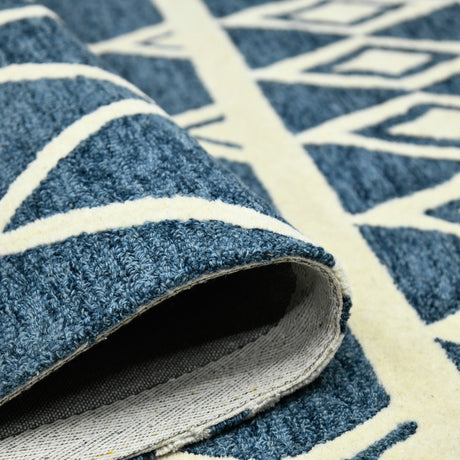 Close-up of rolled rug edge showing navy pile thickness and cream backing detail