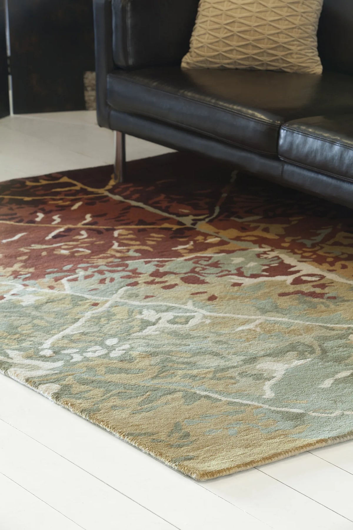 Chandra Nirvana NIR-6604 Green and Red and Burgundy and Brown rug, shown in a styled room setting