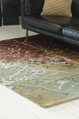 Chandra Nirvana NIR-6604 Green and Red and Burgundy and Brown rug, shown in a styled room setting