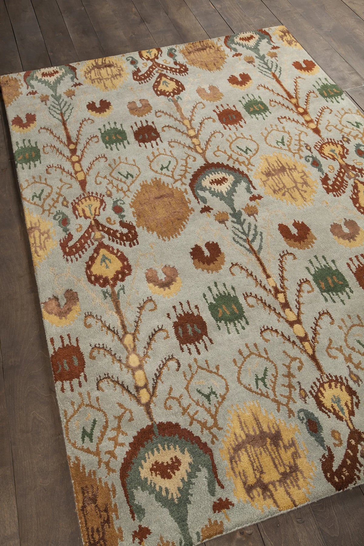 Chandra Rupec RUP-39608 Blue and Brown and Gold and Grey and Green rug, angled side view