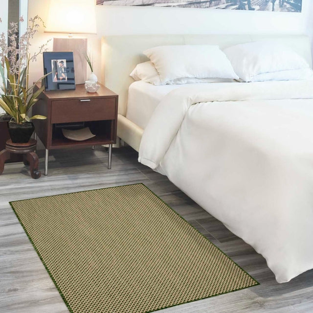 Green rectangle area rug with repeating diamond lattice pattern and flat woven look