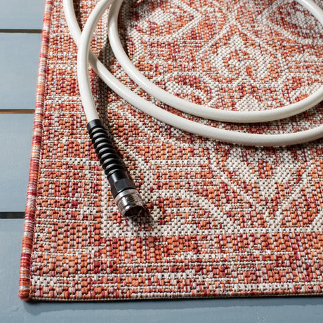 Safavieh Courtyard 5'-3" x 7'-7" Rug in Rust / Light Grey