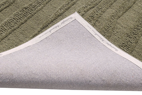 Handmade modern green rug, textured loop pile with visible stitched edge binding