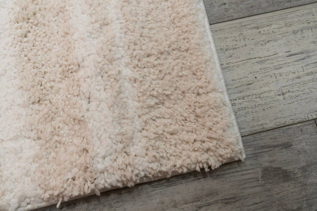 Ivory and beige shag rug with thick plush pile and neatly bound corner edge
