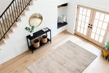 Modern light grey rectangular rug with soft short pile, laid on light wood floor