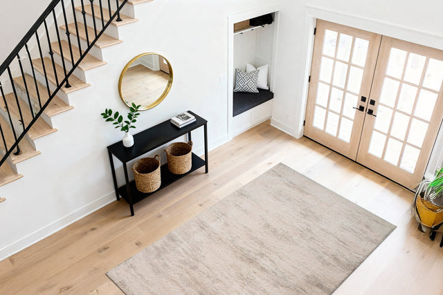 Modern light grey rectangular rug with soft short pile, laid on light wood floor