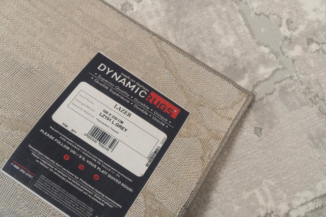 Light grey power-loomed rug with subtle textured geometric pattern and bound edges