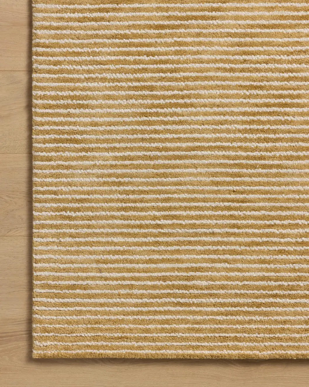 Loloi Sunday SUN-01 Wheat / Ivory Hand Tufted Rug - corner on wood