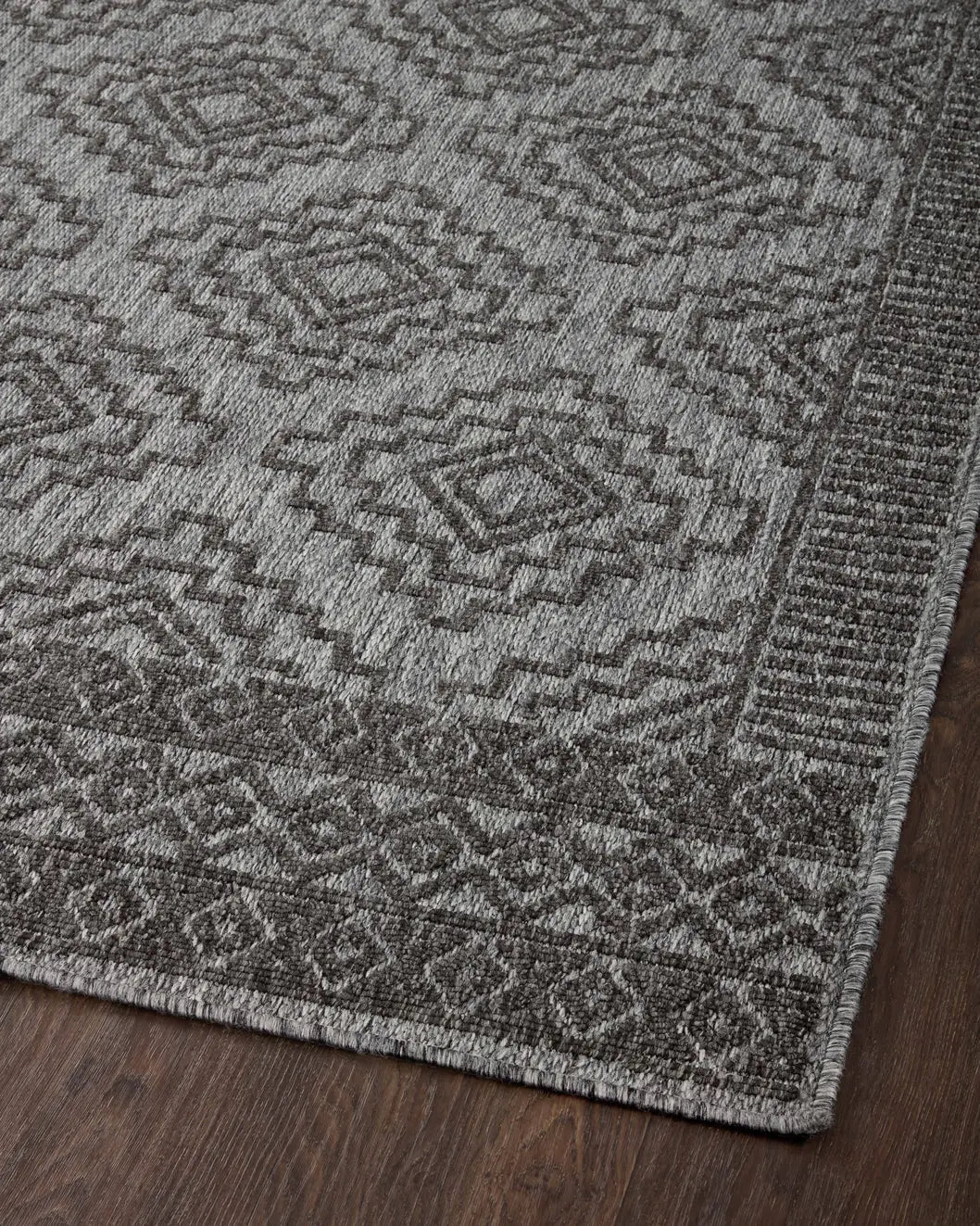Loloi Rainier Rai-06 Grey/Charcoal Rug - angled corner on wood