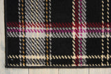 Close-up black plaid area rug with cream, red, purple, and gold grid texture