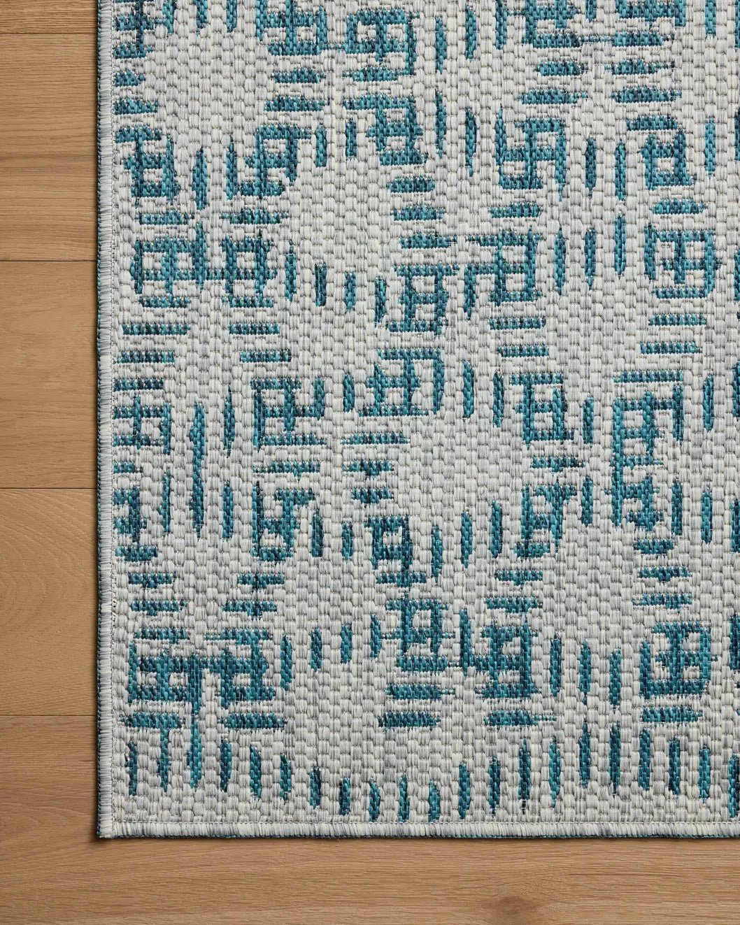 Loloi Easton ESN-10 Fog / Teal Rug - corner on wood