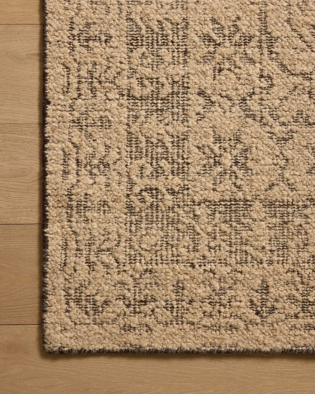 Loloi Novi NVI-01 Tan / Onyx Rug - corner on wood