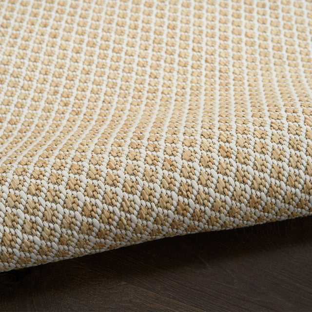 Close-up of natural woven rug with dense lattice stitching and textured pile