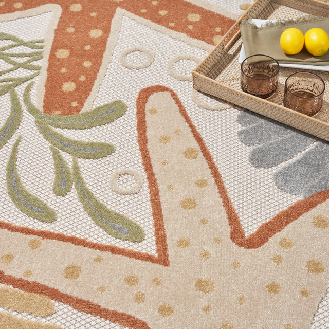 Ivory rug close-up with orange starfish outlines and green leaf patterns