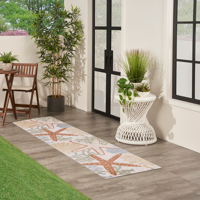 Ivory multicolor runner rug with orange and green starfish motifs
