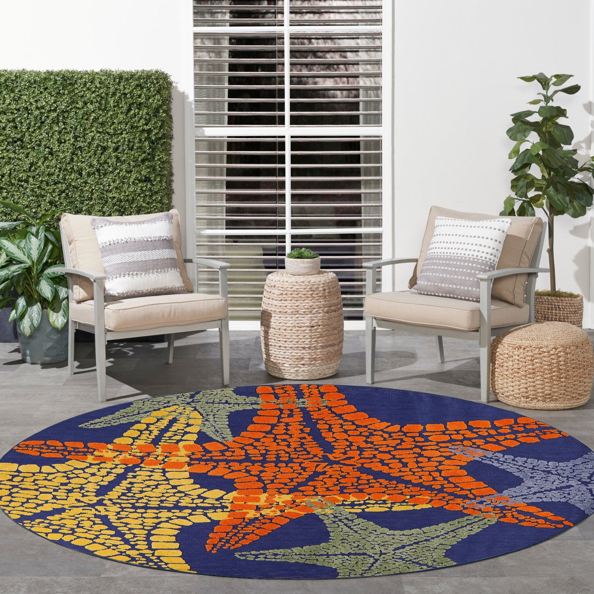 Rectangular multicolor rug featuring dotted starfish pattern in orange, blue, and yellow