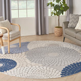 Round area rug with blue and grey geometric medallion pattern and light cream background